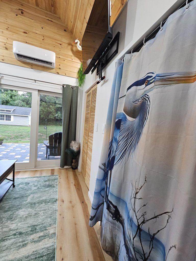 comfortable guest suite with sliding glass doors leading to the backyard